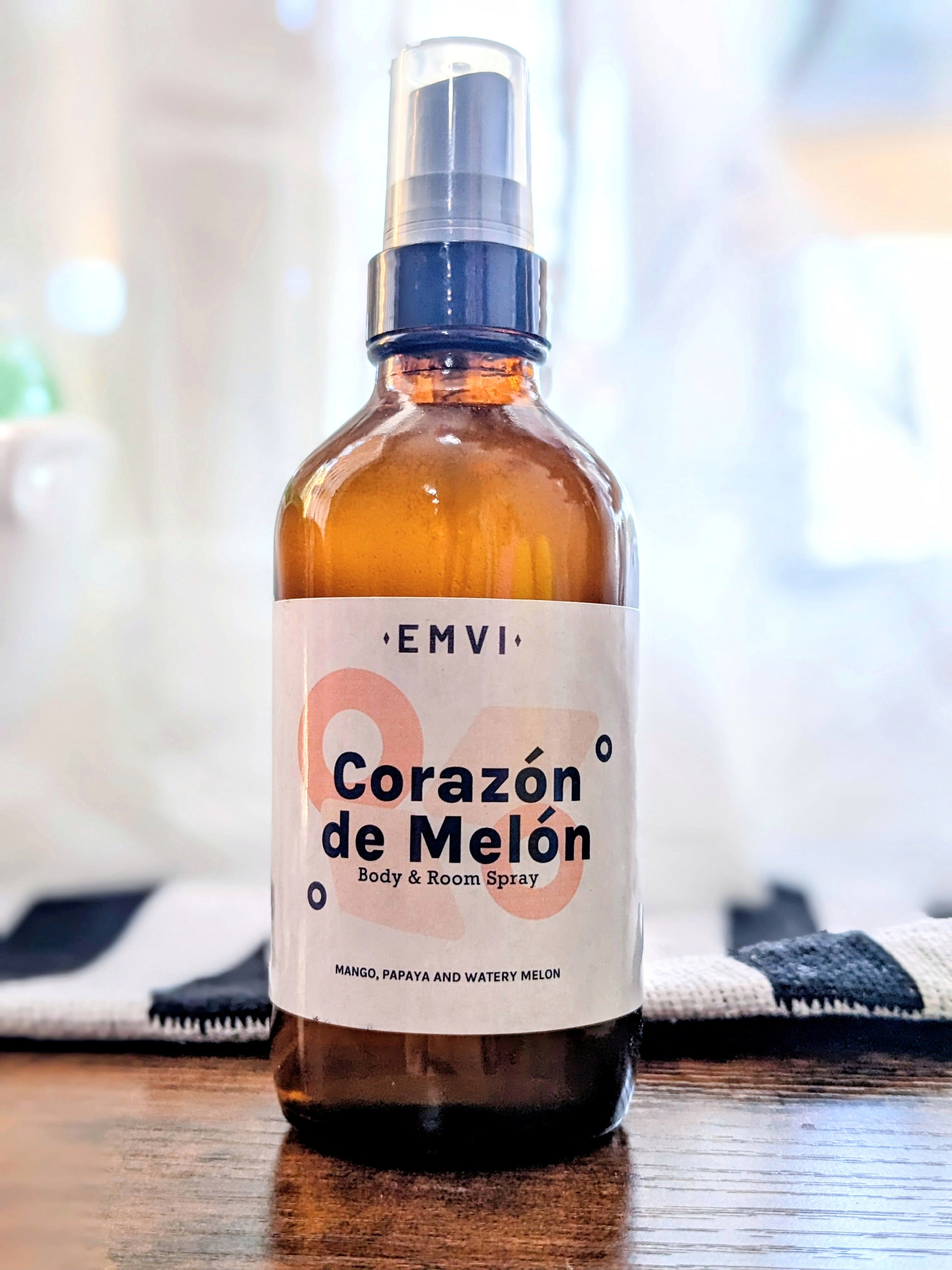 Corazon de Melon body & room spray packaged in an amber glass bottle